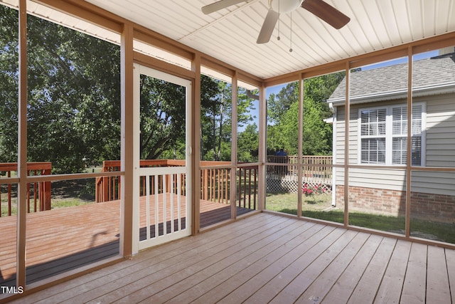 unfurnished sunroom featuring a ceiling fan