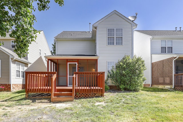 back of house with a lawn, roof with shingles, and a deck