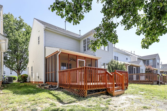 rear view of property with a yard, a deck, ceiling fan, and a sunroom