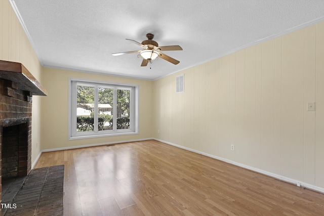 101 Atchison St, Garner, NC 27529 - unfurnished living room with ceiling fan, a fireplace, wood finished floors, visible vents, and ornamental molding