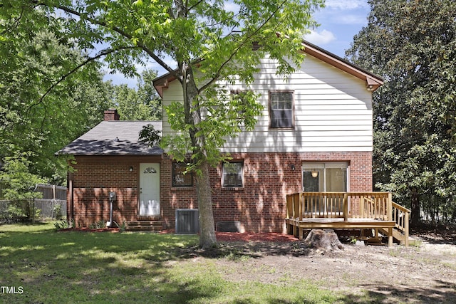 101 Atchison St, Garner, NC 27529 - rear view of house with fence, a deck, cooling unit, brick siding, and a lawn