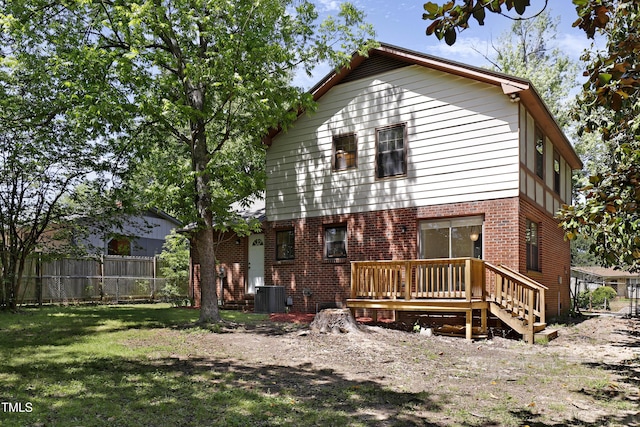 101 Atchison St, Garner, NC 27529 - rear view of property with fence, brick siding, a deck, cooling unit, and a lawn
