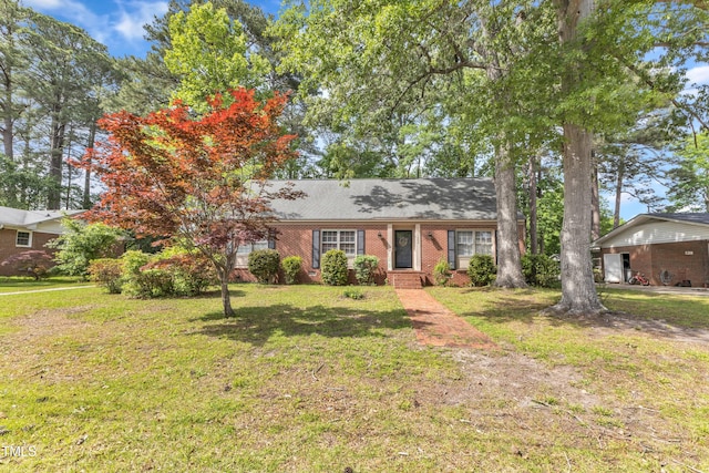 view of front of house featuring brick siding and a front yard