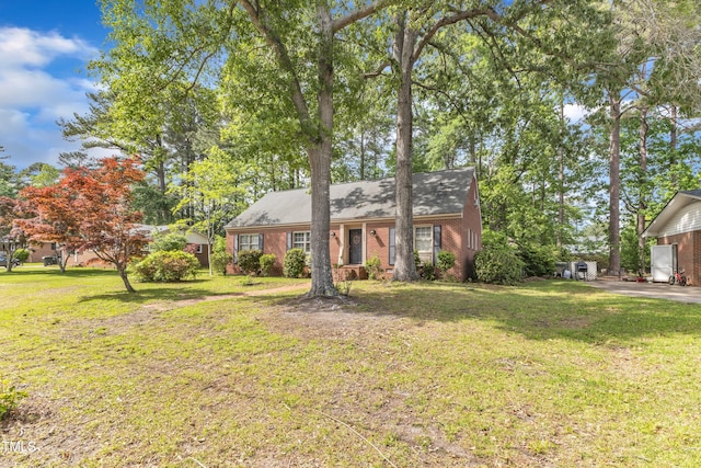 view of front of house with brick siding and a front yard
