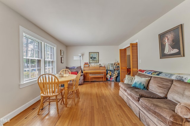 living area with baseboards and light wood-style flooring