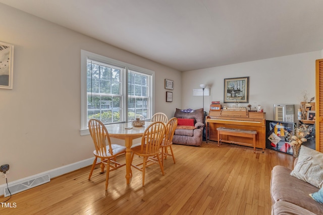 dining area featuring visible vents, wood-type flooring, and baseboards