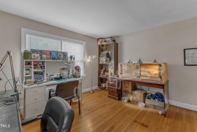 office space featuring baseboards and light wood-type flooring