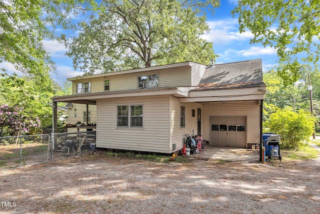 exterior space with a garage, dirt driveway, and fence