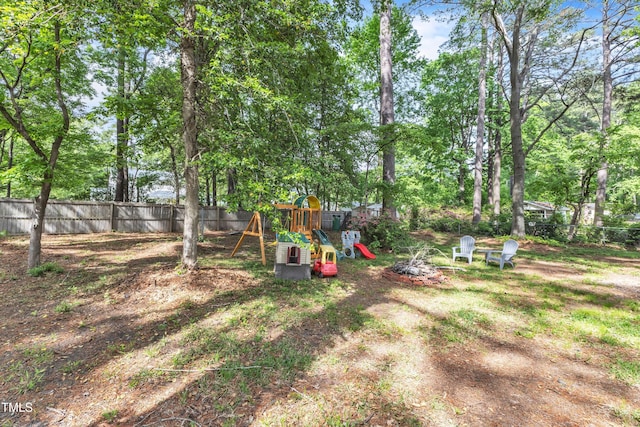 view of yard featuring a playground and fence