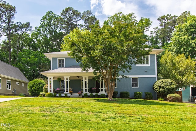 2517 Medway Dr, Raleigh, NC 27608 - view of front of property featuring covered porch, brick siding, a ceiling fan, and a front yard