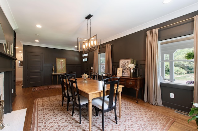 2517 Medway Dr, Raleigh, NC 27608 - dining space with plenty of natural light, ornamental molding, and wood finished floors