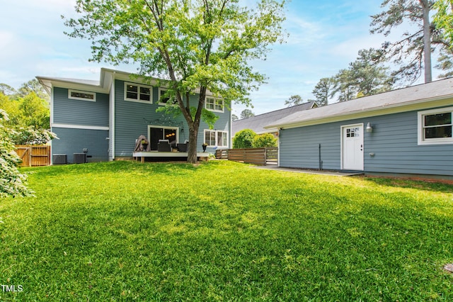 2517 Medway Dr, Raleigh, NC 27608 - rear view of property featuring a lawn, fence, central AC unit, and a deck
