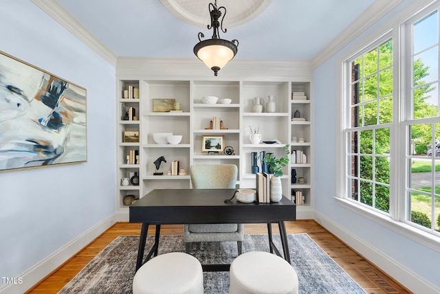 office area featuring baseboards, crown molding, and light wood-type flooring