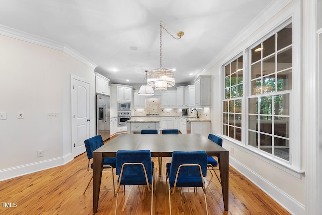 dining area with baseboards, a chandelier, ornamental molding, light wood-style flooring, and recessed lighting