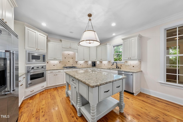 kitchen with built in appliances, a sink, decorative backsplash, light wood-style flooring, and crown molding