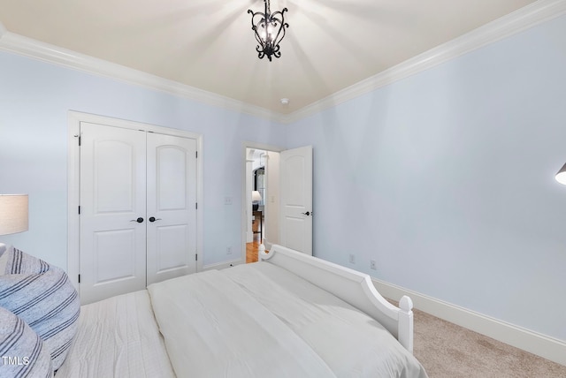carpeted bedroom with crown molding and a closet