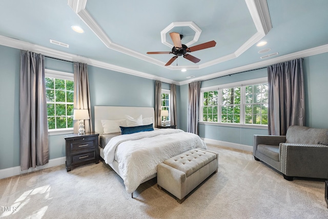 bedroom with crown molding, baseboards, light colored carpet, a tray ceiling, and ceiling fan