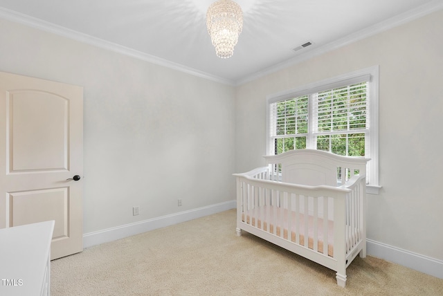 carpeted bedroom with a chandelier, ornamental molding, baseboards, and a nursery area
