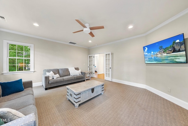 carpeted living area with french doors, a ceiling fan, baseboards, recessed lighting, and ornamental molding