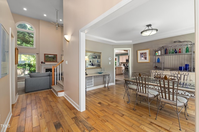 dining room featuring ceiling fan, hardwood / wood-style floors, stairs, recessed lighting, and baseboards