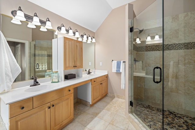 bathroom featuring tile patterned flooring, double vanity, a sink, a stall shower, and vaulted ceiling