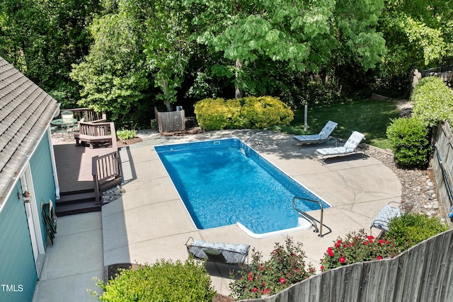 view of pool featuring a fenced in pool, fence, a patio area, and a deck