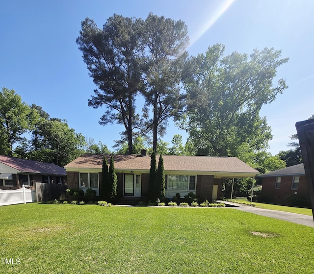 single story home featuring driveway and an attached carport