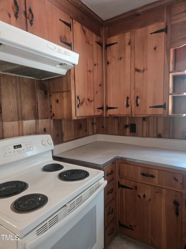 kitchen featuring white electric range, under cabinet range hood, and brown cabinetry