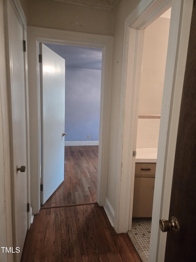 corridor featuring dark wood-style flooring