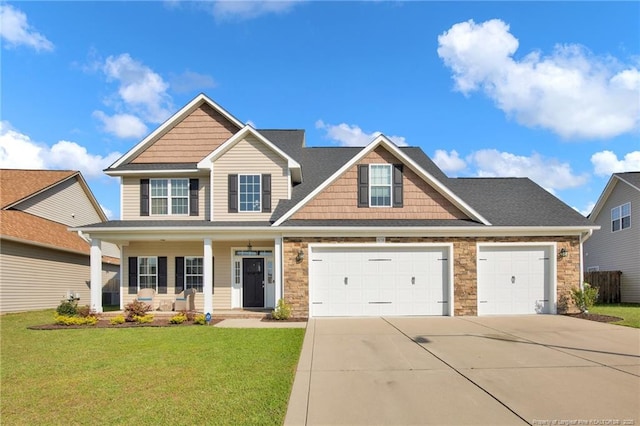 4258 Cherry Hill Ln, Fayetteville, NC 28312 - craftsman-style house featuring covered porch, stone siding, a front yard, an attached garage, and driveway