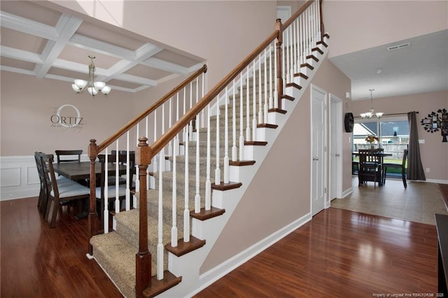 4258 Cherry Hill Ln, Fayetteville, NC 28312 - stairway featuring beam ceiling, coffered ceiling, wood finished floors, and a notable chandelier