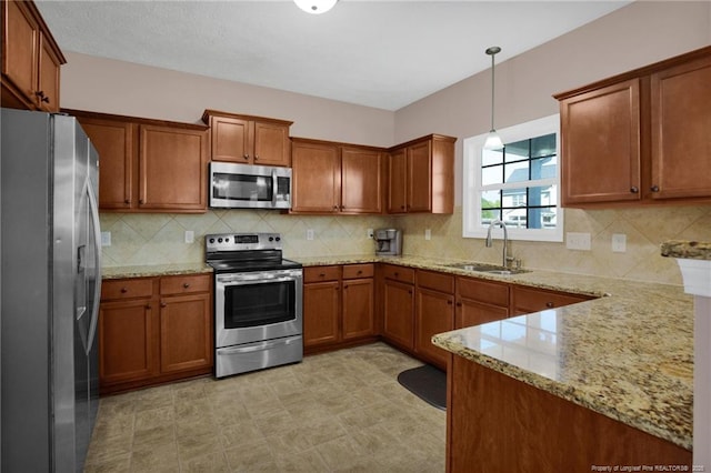 4258 Cherry Hill Ln, Fayetteville, NC 28312 - kitchen with a sink, brown cabinetry, stainless steel appliances, and light stone countertops