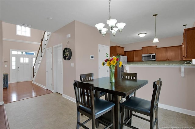 4258 Cherry Hill Ln, Fayetteville, NC 28312 - dining space featuring stairway, baseboards, an inviting chandelier, and visible vents