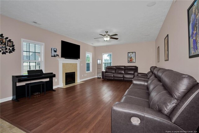 4258 Cherry Hill Ln, Fayetteville, NC 28312 - living area featuring a tiled fireplace, a ceiling fan, baseboards, and wood finished floors