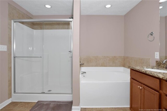 4258 Cherry Hill Ln, Fayetteville, NC 28312 - full bathroom with vanity, recessed lighting, a bath, tile patterned floors, and a stall shower