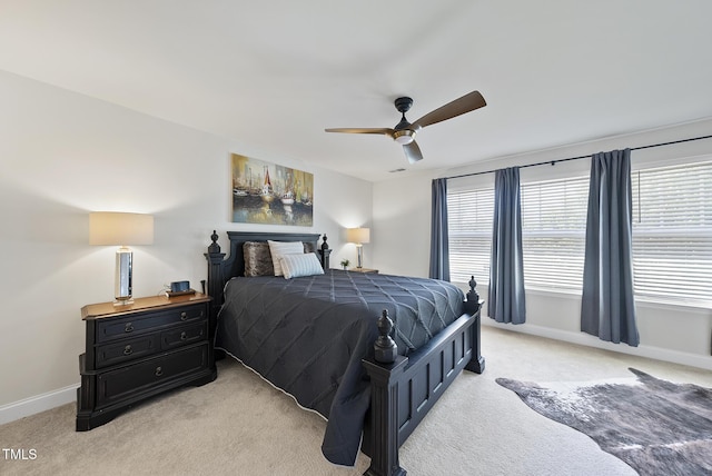 bedroom featuring baseboards, a ceiling fan, and light colored carpet