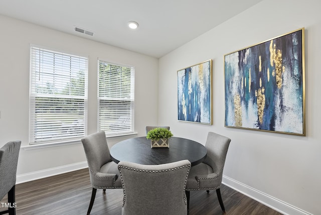dining area featuring baseboards, dark wood-style flooring, and visible vents