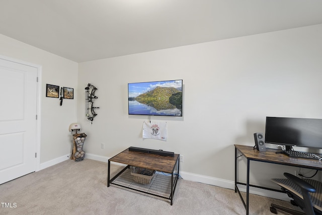 office space featuring baseboards and light carpet