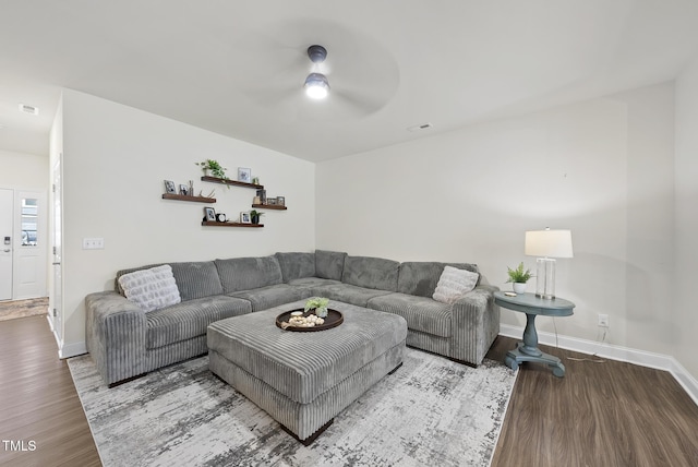 living room with baseboards, a ceiling fan, wood finished floors, and visible vents