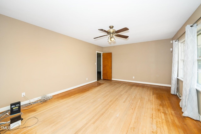 unfurnished living room featuring light wood-style floors, baseboards, and ceiling fan