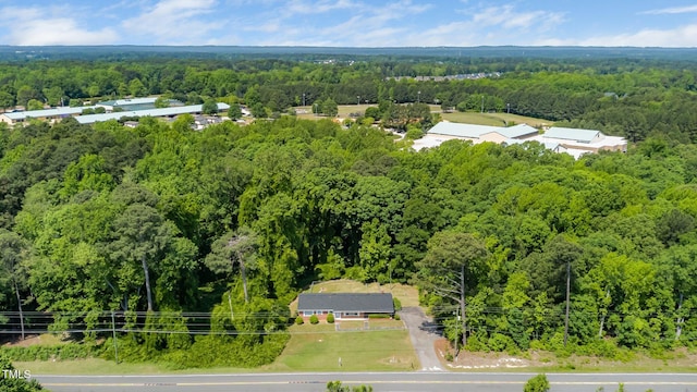 drone / aerial view featuring a forest view