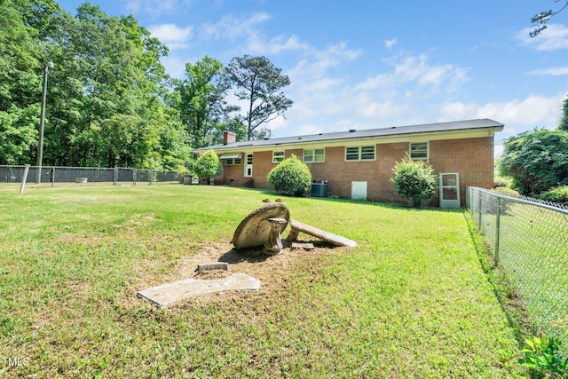view of yard featuring a fenced backyard and central air condition unit