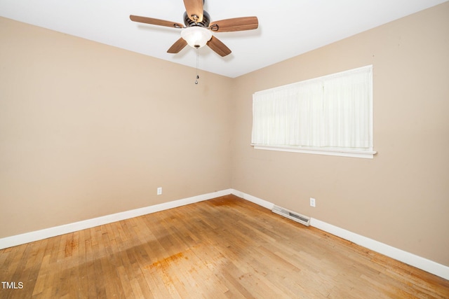 unfurnished room with baseboards, visible vents, ceiling fan, and light wood finished floors
