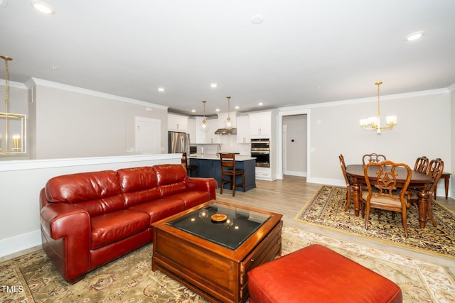 living room with baseboards, crown molding, and a chandelier