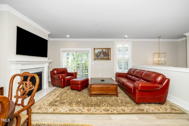 living room with baseboards, ornamental molding, a healthy amount of sunlight, and a high end fireplace