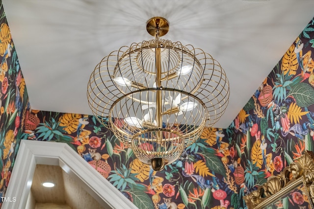 details featuring wallpapered walls and a chandelier