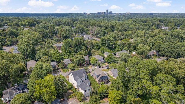 birds eye view of property featuring a wooded view