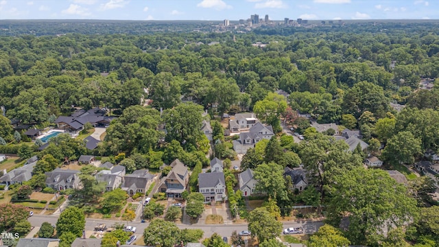bird's eye view featuring a residential view and a wooded view