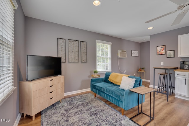 living area with baseboards, a ceiling fan, recessed lighting, and light wood-type flooring