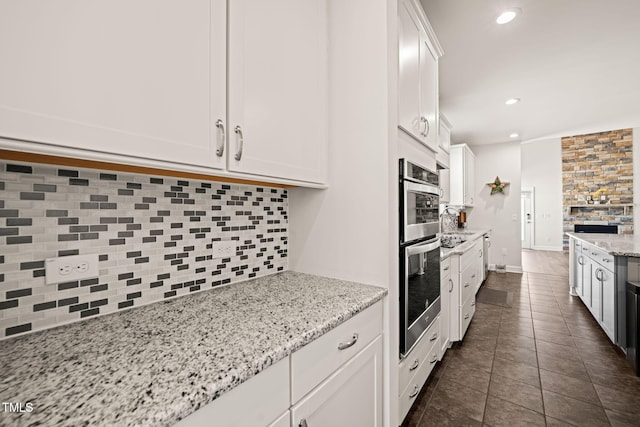 6633 Penfield St, Wake Forest, NC 27587 - kitchen with tasteful backsplash, white cabinets, dark tile patterned flooring, and recessed lighting